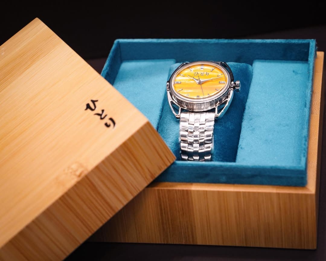 A Hitori with a yellow dial in its bamboo presentation box